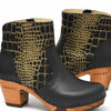 [Schwarz-Cocco Gold] Tanja Damen Clog Stiefelette, woody holzschuhe. tanya ankle boots gefüttert, damenstiefel, stiefel, damenclogs mit flexibler, biegsamer holzsohle. holzclogs, clogs damen knöchel stiefel, damen clogs mit fussbett. ankleboots holz schuhe, holzclog, holzschuhe kaufen, farbe: schwarz - cocco gold